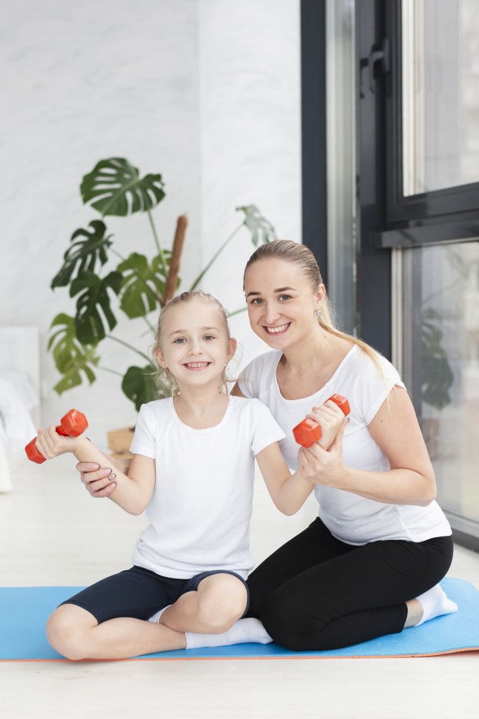 front-view-mother-posing-with-daughter-weights.jpg